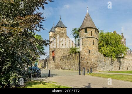 L'Helpoort o Jekerpoort con la sua porta tra due torri e una torre sulla riva fanno parte del Primo muro medievale a Maastrich vicino alla città Foto Stock