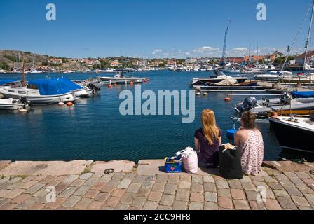 Giovani donne che si rilassano al porto di Marstrand, Svezia Foto Stock