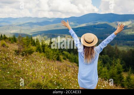 Viaggiare in Ucraina estate. Gita ai Monti Carpazi. Felice donna turistica trekking alzando le braccia Foto Stock