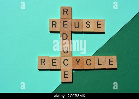 Ridurre, riciclare, riusare, parole in lettere alfabetiche in legno in forma di croceparola isolate su sfondo verde e turchese Foto Stock