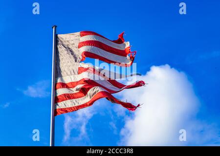 08.08.2013, Berlino, Stelle e strisce, una bandiera degli Stati Uniti d'America che sventola nel vento in una versione estremamente frantumata come simbolo di uno stato disperato degli Stati Uniti contro un cielo blu e leggermente nuvoloso. La bandiera mostra sette strisce rosse e sei strisce bianche, che stanno per i 13 stati fondatori, e un campo bandiera blu nell'angolo in alto a sinistra, le cui attualmente 50 stelle bianche simboleggiano i 50 stati degli Stati Uniti. | utilizzo in tutto il mondo Foto Stock