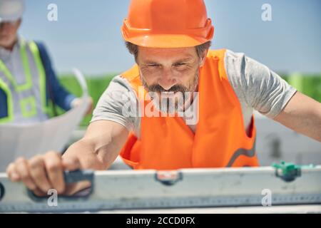 Due uomini in caschi si sono concentrati sul loro lavoro Foto Stock