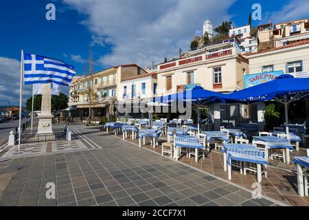 Ristoranti sul lungomare del porto nel villaggio di Chora dell'isola di Poros. Foto Stock