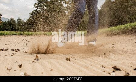 Golfer. Professionale colpisce la sfera dalla trappola di sabbia. Bali. Inodesia. Foto Stock