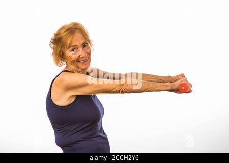 Donna anziana che si esercita con due Dumbbells della libbra Foto Stock