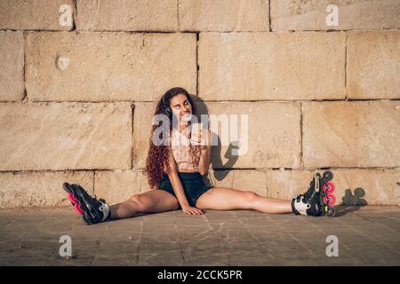 Giovane donna pattinaggio sul Boardwalk presso la costa Foto Stock