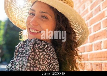 Primo piano di sorridente bella donna che indossa cappello Foto Stock