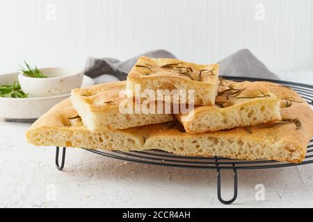 Focaccia, pizza, pane italiano piatto con rosmarino e olio d'oliva su griglia Foto Stock
