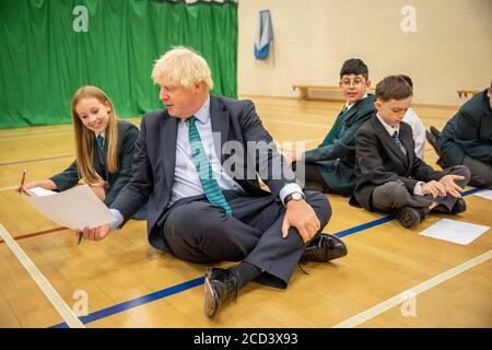 Primo Ministro Boris Johnson con Olivia Stokes in palestra partecipando a una sessione di induzione con anni sette come egli tour Castle Rock scuola, Coalville, nelle Midlands orientali. Foto Stock