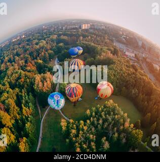 Vista panoramica dei ballon ad aria calda preparati per un decollo mattutino dal parco nella piccola città europea, nella regione di Kiev, Ucraina Foto Stock