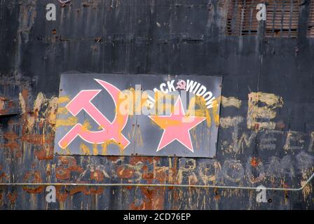 Martello e siclke e stella a cinque punte, e graffiti variour, sul lato dell'ex sommergibile russo U-475 Black Widow sul fiume Medway Kent, Inghilterra Foto Stock