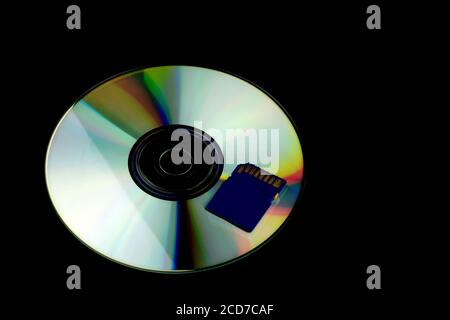 Compact Disc e scheda di memoria isolati su sfondo nero Foto Stock