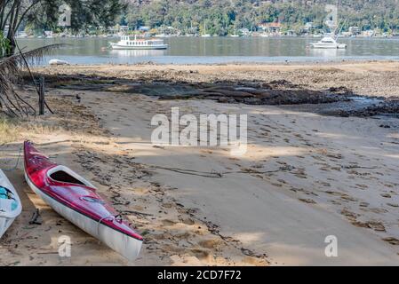 I kayak vuoti si siedono sulla spiaggia di Bradleys Beach sull'Isola di Dangar nel Fiume Hawkesbury 55 km a nord di Sydney, Australia Foto Stock