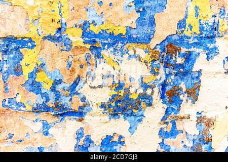 Muro colorato di intonaco danneggiato con peeling fiocchi di vernice Foto Stock