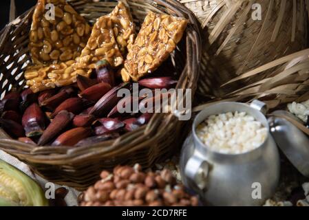 Cibi tipici. Feste di São João. Prelibatezze del mese di giugno. Arachidi, mais verde, popcorn, pinoli e hominy. Divertimento popolare. Rapadura in Foto Stock