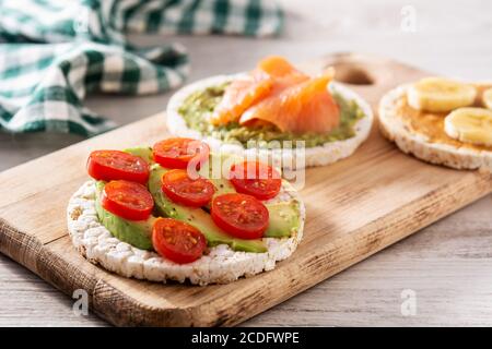 Assortimento di ingredienti su torte di riso soffiato su tavolo di legno Foto Stock