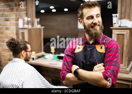 Uomo che ha un taglio di capelli con un regolacapelli nel salone di barbiere Foto Stock