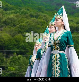 Adygea, RUSSIA - LUGLIO 25 2015: Giovani ragazze in Adyghe costumi nazionali danzare la danza tradizionale in un ethnosurge nelle colline del Caucaso in UN Foto Stock