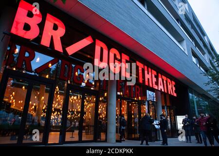 Londra, Regno Unito: 28 agosto 2020: I membri del pubblico arrivano al Bridge Theatre, che ha riaperto questa settimana per il pubblico dal vivo. Ralph Fiennes esegue un monologo autobiografico di David Hare, 'Beat the Devil', sulla pandemia del coronavirus e l'esperienza personale del drammaturgo di soffrire di COVID-19. Un pubblico di soli 250 persone sedette su sedili socialmente distanziati e fu chiesto di indossare copriviso ovunque. Anna Watson/Alamy Live News Foto Stock