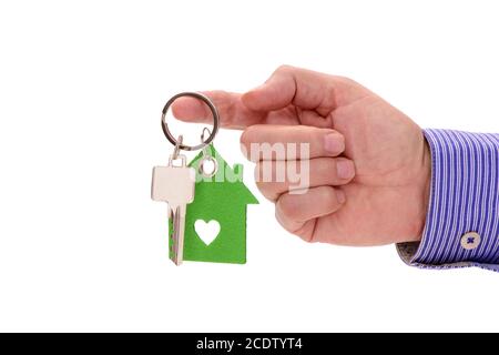 Chiave di casa sulla corona nella mano di agente immobiliare Foto Stock