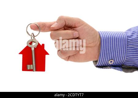 Chiave di casa sulla corona nella mano di agente immobiliare Foto Stock