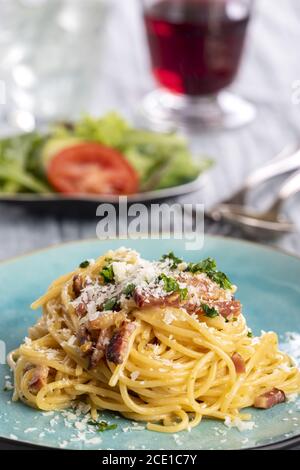 Spaghetti carbonara su piastra blu Foto Stock