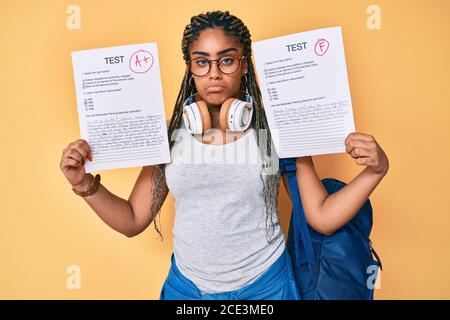 Giovane afroamericana con le trecce che mostrano fallito e superato esame depresso e la preoccupazione per la sofferenza, piangendo arrabbiato e paura. Espressione triste. Foto Stock