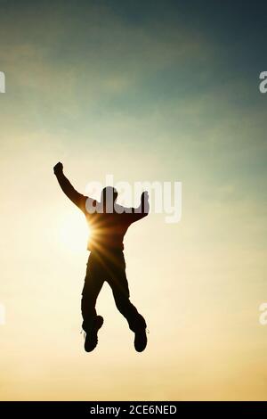 Volare uomo in aria. Uomo che cade su sfondo cielo colorato. Stile vintage Foto Stock