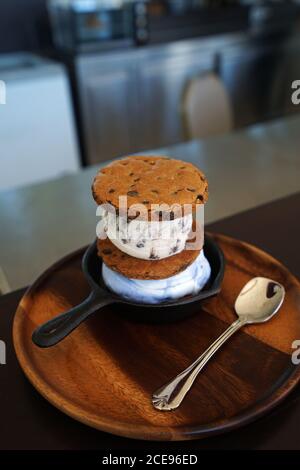 Biscotti e panino gelato servito su un piatto di legno Foto Stock