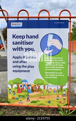 Bexley Council Playground Firma che dà indicazioni al governo sull'uso di disinfettante per le mani e di distanziamento sociale. Foots Cray Meadows Playground, Sidcup, Kent. REGNO UNITO Foto Stock