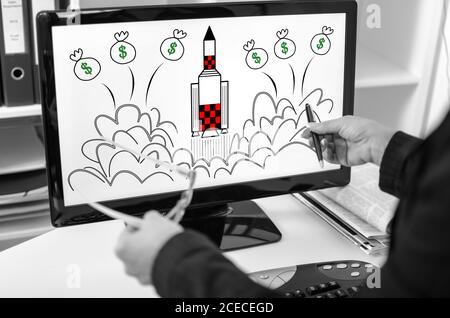 Uomo d'affari che mostra il concetto di avvio su uno schermo del computer Foto Stock