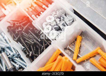 Custodia con piccoli oggetti da costruzione. Set di viti, ancoraggi, chiodi, bulloni in metallo Foto Stock