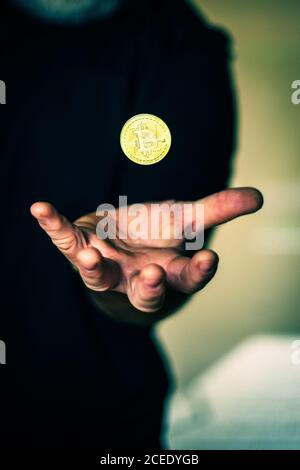 Moneta di bitcoin dorata che galleggia sopra la mano Foto Stock