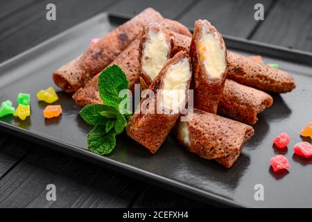 Dolce frittella sottile con cioccolato, formaggio caserario e frutta Foto Stock