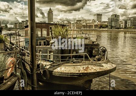 Houseboats si oppone all'architettura di gentrifificazione lungo il fiume Tamigi a Battersea, Greater London, England, United Kingdom, Europe Foto Stock