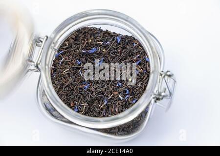 Earl Grey con tè in foglie di fior di mais in un deposito vasetto su sfondo bianco Foto Stock