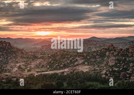 L'alba rocciosa di montagna si inardisce con il cielo drammatico al mattino, ad angolo piatto, è scattata alla collina di Matanga hampi karnataka india. La vista da qui è seren Foto Stock