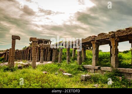 hampi bazaar rovine di antica pietra d'arte da un angolo unico con cielo incredibile Foto Stock