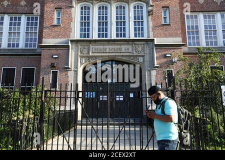 (200902) -- NEW YORK, 2 settembre 2020 (Xinhua) -- UN uomo passa davanti a una scuola pubblica a New York, Stati Uniti, 1 settembre 2020. Il sindaco di New York Bill de Blasio ha annunciato martedì che la riapertura del sistema scolastico pubblico della città sarà posticipata. (Xinhua/Wang Ying) Foto Stock