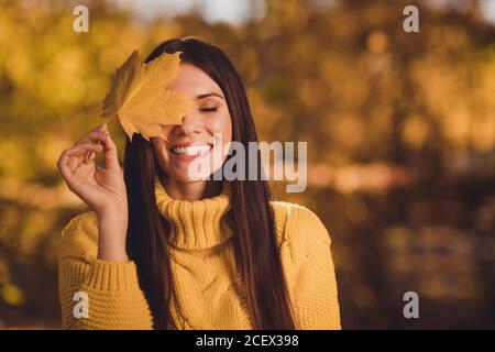 Primo piano ritratto di positivo allegro donna ambiente amante godere riposo relax autunno parco naturale vicino copertura occhio faccia acero usura a foglia lavorata a maglia Foto Stock