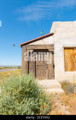 Porta intagliata in vecchio edificio desertico lungo l'autostrada Route 66 Arizona. Foto Stock