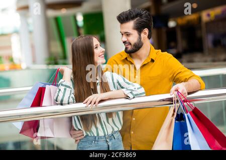 Ritratto del suo lui lei bella bella bella affascinante allegro coppia allegra abbracciando il trasporto di nuovi vestiti che visitano il negozio uscita Foto Stock