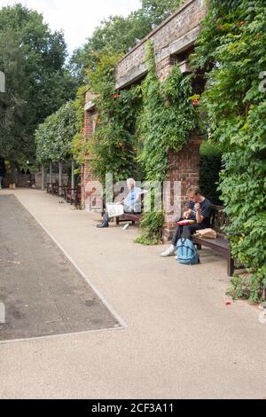 Persone che si rilassano in Holland Park, Holland Park Avenue, Kensington, Londra, W11, Regno Unito Foto Stock