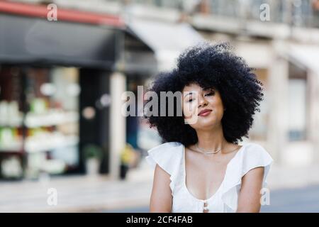 Giovane African American Woman ritratto rilassante guardando la fotocamera all'aperto Foto Stock