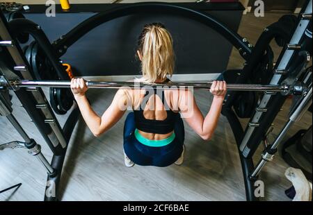 Sollevamento donna barbell in palestra Foto Stock