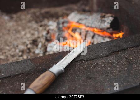 Coltello da caccia accanto al caminetto Foto Stock