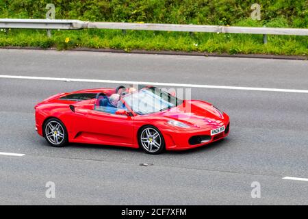 2005 Red Ferrari F430 Spider F1; veicoli in movimento per il traffico veicolare, macchine sportive su strade del Regno Unito, motori, motori sulla rete autostradale M6. Foto Stock