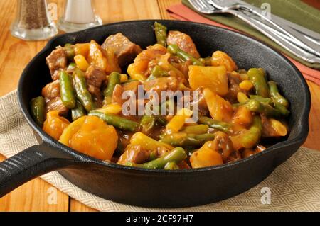 Casseruola di manzo, fagioli e patate in una padella di ghisa Foto Stock