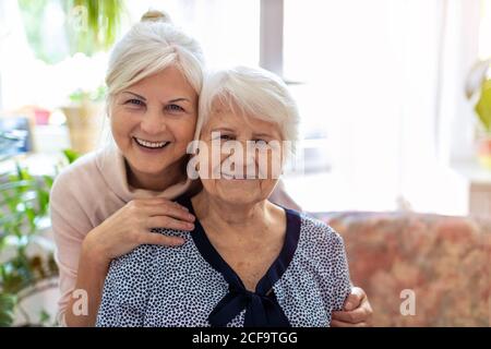 Donna che passa il tempo con la madre anziana Foto Stock