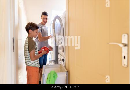 Caricamento della lavatrice a casa Foto Stock